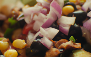 Taco salad with red onions, black beans, corn, avocado, and cilantro lime dressing.