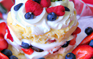 Triple Berry Shortcake: Layers of fluffy shortcake, whipped cream, and fresh strawberries, blueberries, and raspberries.