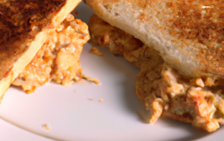 Tuna Melt Sandwich: canned tuna mixed with mayo and spices, topped with cheese and broiled until melted on a toasted bun.