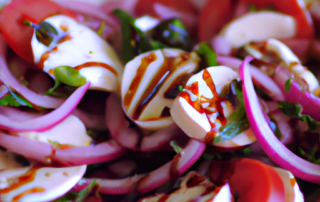 Caprese salad with red onions, fresh mozzarella, tomatoes, basil, and balsamic glaze